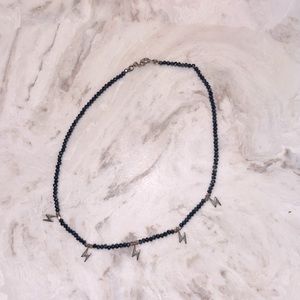 Dark navy blue, with lightning bolt chocker.